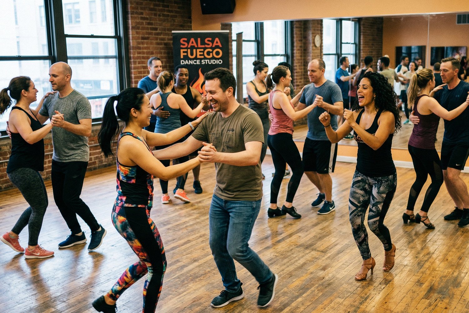 People dancing salsa at a dance class